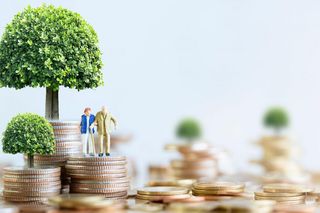Pièces empilées avec arbre miniature et figurines – Dynamique positive des produits d’épargne AXA